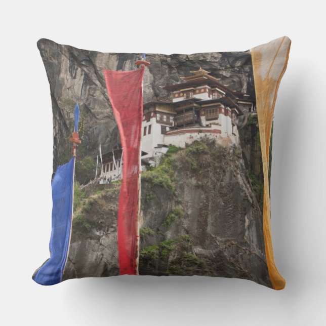 Prayer flags hang near Taktshang Throw Pillow (Front)