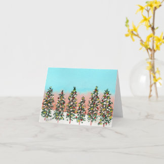 Pre-dawn row of colourful Christmas trees Card