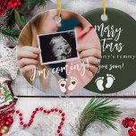 Pregnancy Merry Christmas baby ultrasound photo Ceramic Ornament<br><div class="desc">Modern funny I'm coming see your soon script,  footprints,  and red hearts new baby expecting keepsake Merry Christmas from mommy's tummy dark green tree ornament with your custom ultrasound photo.</div>