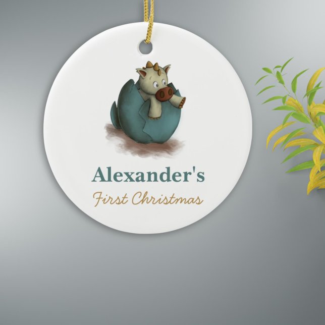 Première décoration de Noël neutre avec un dinosau (Cute first christmas keepsake with a dinosaur hatching from a green egg)