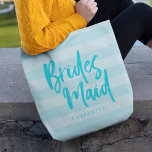 Preppy Blue Stripes Brush Script Bridesmaid Tote Bag<br><div class="desc">Personalized Bridesmaid tote bag featuring the word "Bridesmaid" in trendy brush script against a preppy blue stripes background that's perfect for your bridesmaid to carry her items. Check out the matching makeup bag here https://www.zazzle.com/preppy_blue_stripes_brush_script_bridesmaid_makeup_bag-223509437047049384?rf=238364477188679314 Personalize it by replacing the placeholder text. For more options such as to change the font...</div>