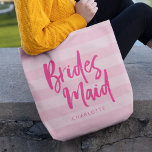 Preppy Pink Stripes Brush Script Bridesmaid Tote Bag<br><div class="desc">Personalized Bridesmaid tote bag featuring the word "Bridesmaid" in trendy brush script against a preppy pink stripes background that's perfect for your bridesmaid to carry her items. Check out the matching makeup bag here https://www.zazzle.com/preppy_pink_stripes_brush_script_bridesmaid_makeup_bag-223977580678893594?rf=238364477188679314 Personalize it by replacing the placeholder text. For more options such as to change the font...</div>