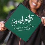 Preppy Script Green Graduation Cap Topper<br><div class="desc">Customize your graduation cap by adding a personalized graduation cap topper. The graduation cap topper features "Graduate" in a white handwritten script with a green background or colour of your choice. Personalize the green graduation cap topper by adding the graduate's name and graduation year.</div>