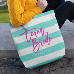 Preppy Turquoise and White Stripes Pink Team Bride Tote Bag<br><div class="desc">All-Over-Print Tote bag featuring the words "Team Bride" in pink trendy script against a turquoise and white stripes pattern background. Perfect for weddings for bridesmaids, maid of honour and flower girl. For other colours and matching items see here https://www.zazzle.com/collections/119250194970828530?rf=238364477188679314 Personalize it by replacing the placeholder text. For more options such...</div>