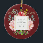 Pretty Girly Flowers Baby's First Christmas Ceramic Ornament<br><div class="desc">This beautiful ornament features lovely watercolor style pink peonies and grey and green leaves on a burgundy background. A square frame with faux gold foil is in the centre, and you can personalize with your baby's name and any message or year by using the template. (PLEASE NOTE: the gold look...</div>