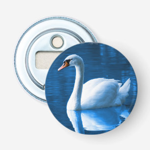 Pretty white swan floating on a blue lake bottle opener