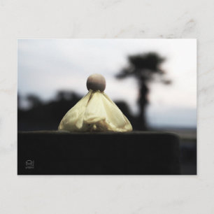 Proud wooden figurine on catwalk in yellow dress. postcard