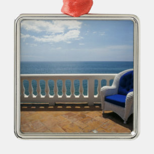 Puerto Rico. Wicker chair and tiled terrace at Metal Ornament