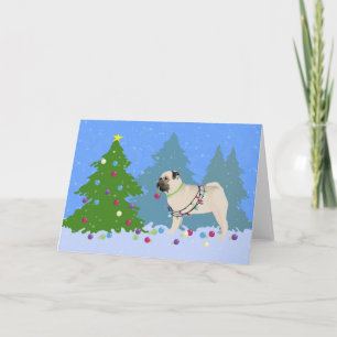 Pug decorating a Christmas Tree in the forest Holiday Card