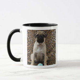 Pug puppy sitting against animal print 2 mug