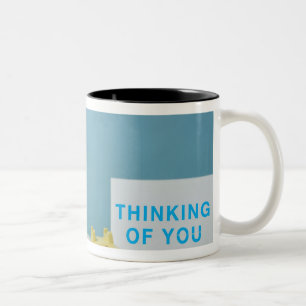 Pug puppy sitting on bed next to phone and Two-Tone coffee mug