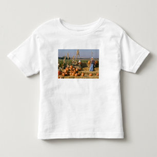 Pumpkin display with hay bales and scarecrows toddler t-shirt