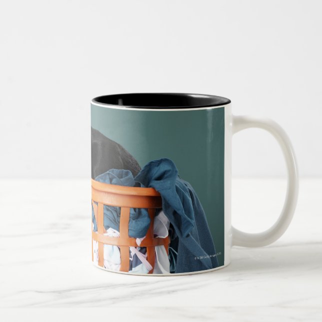 Puppy lying in laundry basket Two-Tone coffee mug (Right)
