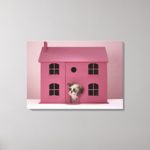 Puppy peering out of doll's house canvas print