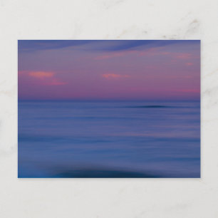 Purple-coloured sunrise on ocean shore postcard