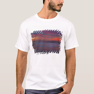 Purple-coloured sunrise on ocean shore T-Shirt