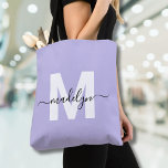 Purple Elegant Script Name Monogram Tote Bag<br><div class="desc">Personalized Girly Light Purple and White Trendy Modern Script Name Monogram Tote Bag. Add a soft and feminine touch to your everyday style with this chic and playful tote bag. Featuring a light purple background and a bold white initial (with no shimmer or foil), paired with a sleek black script...</div>