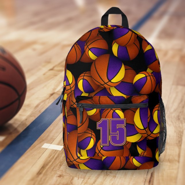 Purple gold kids basketball team colours  printed backpack (On gymnasium floor: Basketball player's backpack w purple/gold team colors, athlete jersey number)