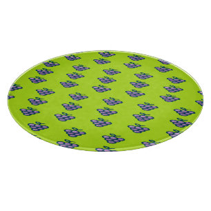 Purple grapes pattern on green cutting board