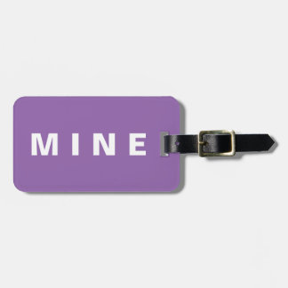 Purple luggage tag with 'Mine' written on it