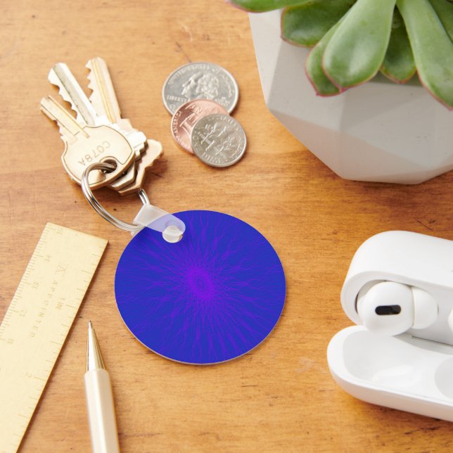 Purple mandala rays on blue keychain (Desk)