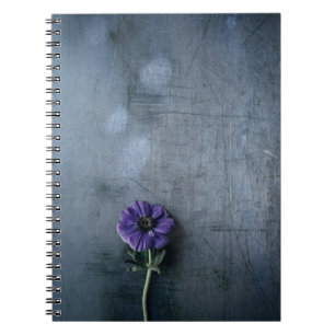 Purple petaled flower on gray surface notebook