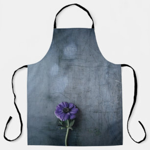 Purple petaled flower on grey surface apron