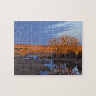 Puzzle Baigné dans la lumière du coucher de soleil, la ri