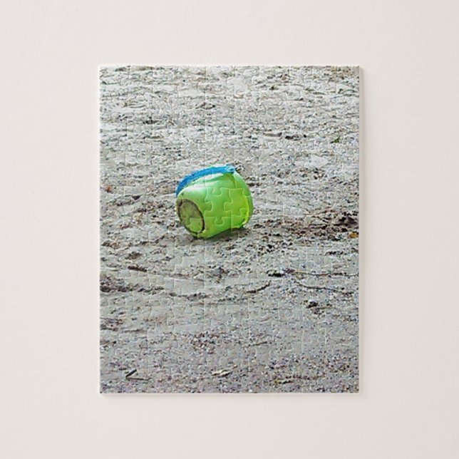 Puzzle Bouche verte perdue dans le sable sur la plage d'é (Vertical)