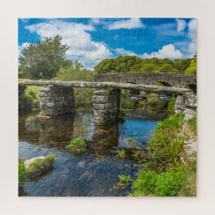 Puzzle Medieval clapper bridge over river in Dartmoor UK