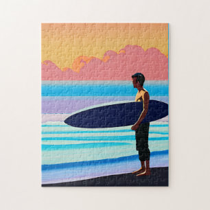 Puzzle Surfer debout sur une plage au coucher du soleil