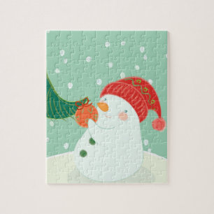 Puzzle Un bonhomme de neige accrochant un ornement sur un
