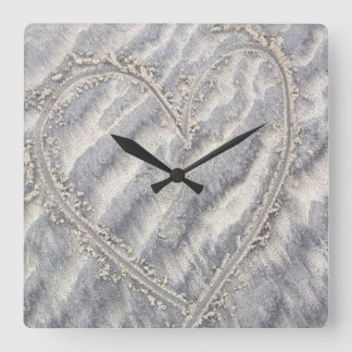 Quirky heart drawing in the sand square wall clock