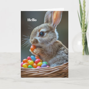 Rabbit eats jelly beans in Easter basket Card