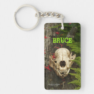 Raccoon skull old log with ferns and red Monarda Keychain