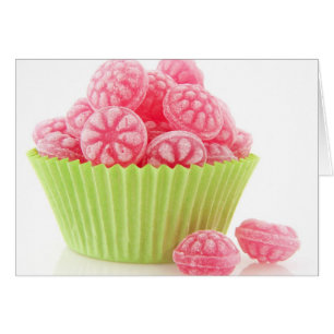 Raspberry tasty candy sweets in green cup cake