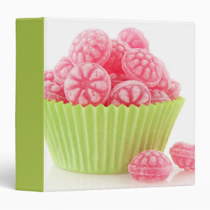 Raspberry tasty candy sweets in green cup cake binder