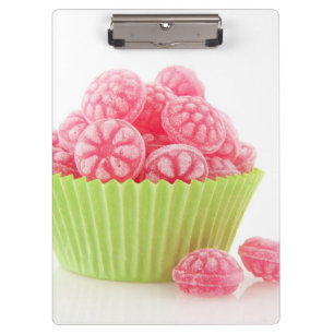 Raspberry tasty candy sweets in green cup cake clipboard
