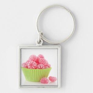 Raspberry tasty candy sweets in green cup cake keychain