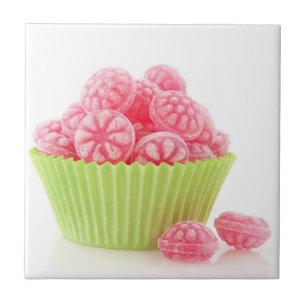 Raspberry tasty candy sweets in green cup cake tile