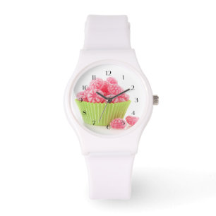 Raspberry tasty candy sweets in green cup cake watch