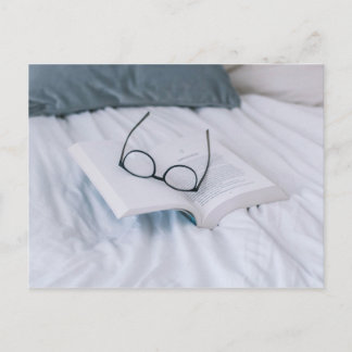 reading in bed minimal white sheets literary postcard