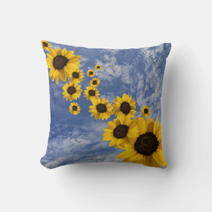 Realistic sunflowers blowing in Cornish sky Throw Pillow