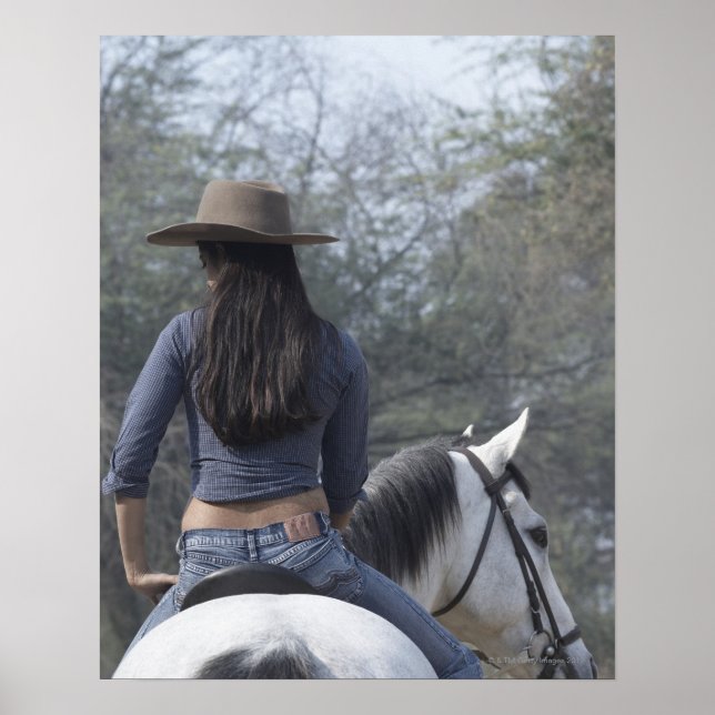 Rear view of a woman riding a horse poster (Front)