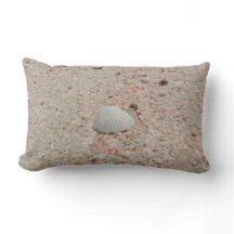 Coquillage blanc et coussin rose de plage de sable