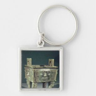 Rectangular 'ting' vessel with human faces keychain