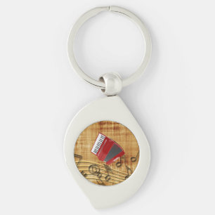 Red accordion, black notes, gold background keychain