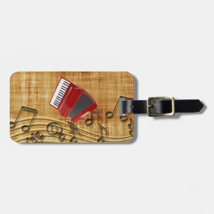 Red accordion, black notes, gold background luggage tag