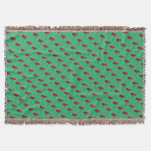 Red and blue poppy flower on green throw blanket