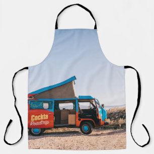 Red and blue vehicle beside man apron